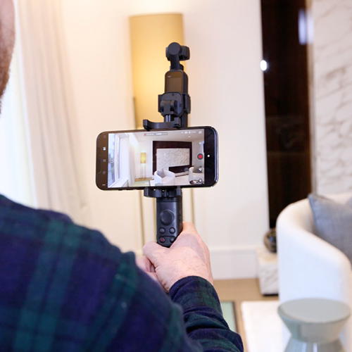 an image of a real estate agent filming a real estate video tour