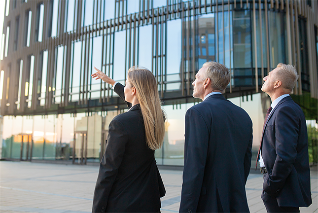 Image of property developers standing outside a new development.