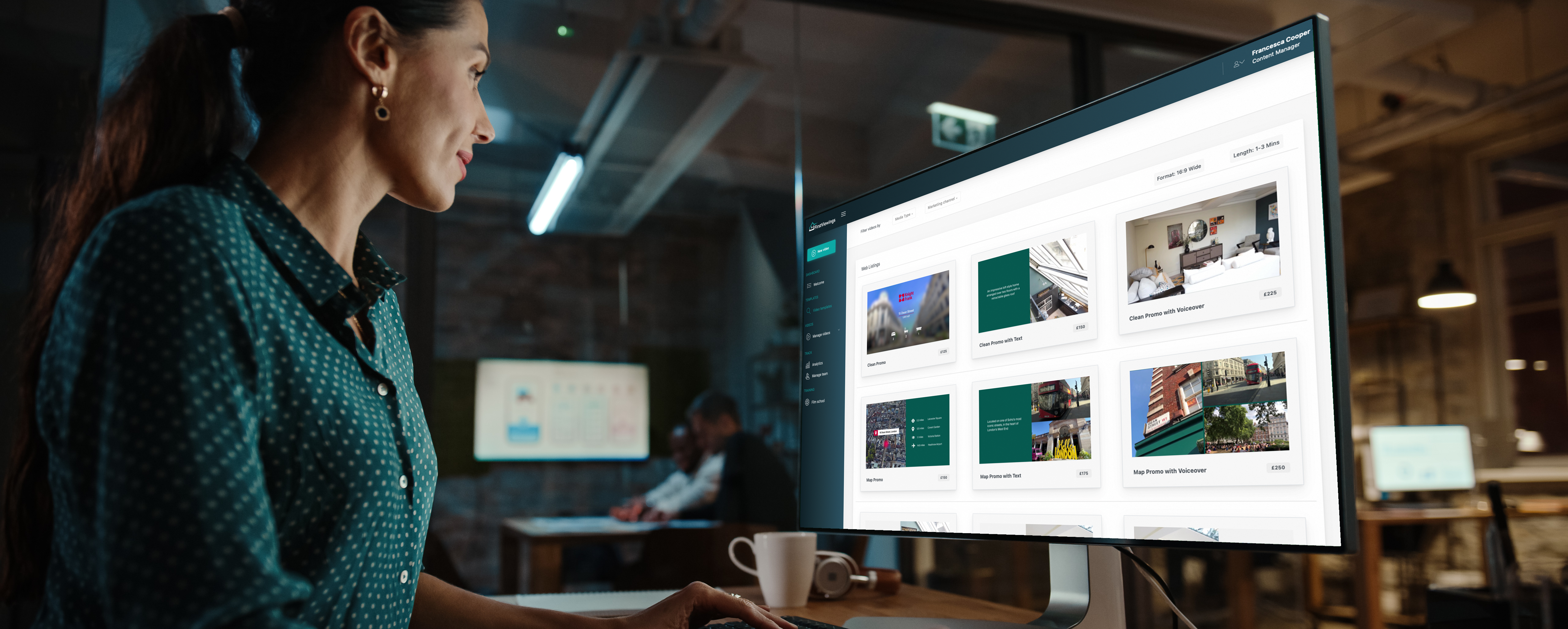 An image of a real estate agent at a desk in front of a computer using the First Viewings real estate video platform.